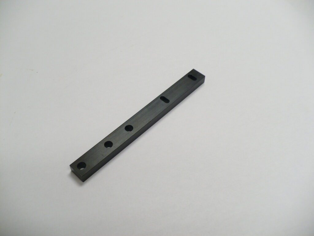 A black Mounting Bar with holes for screws